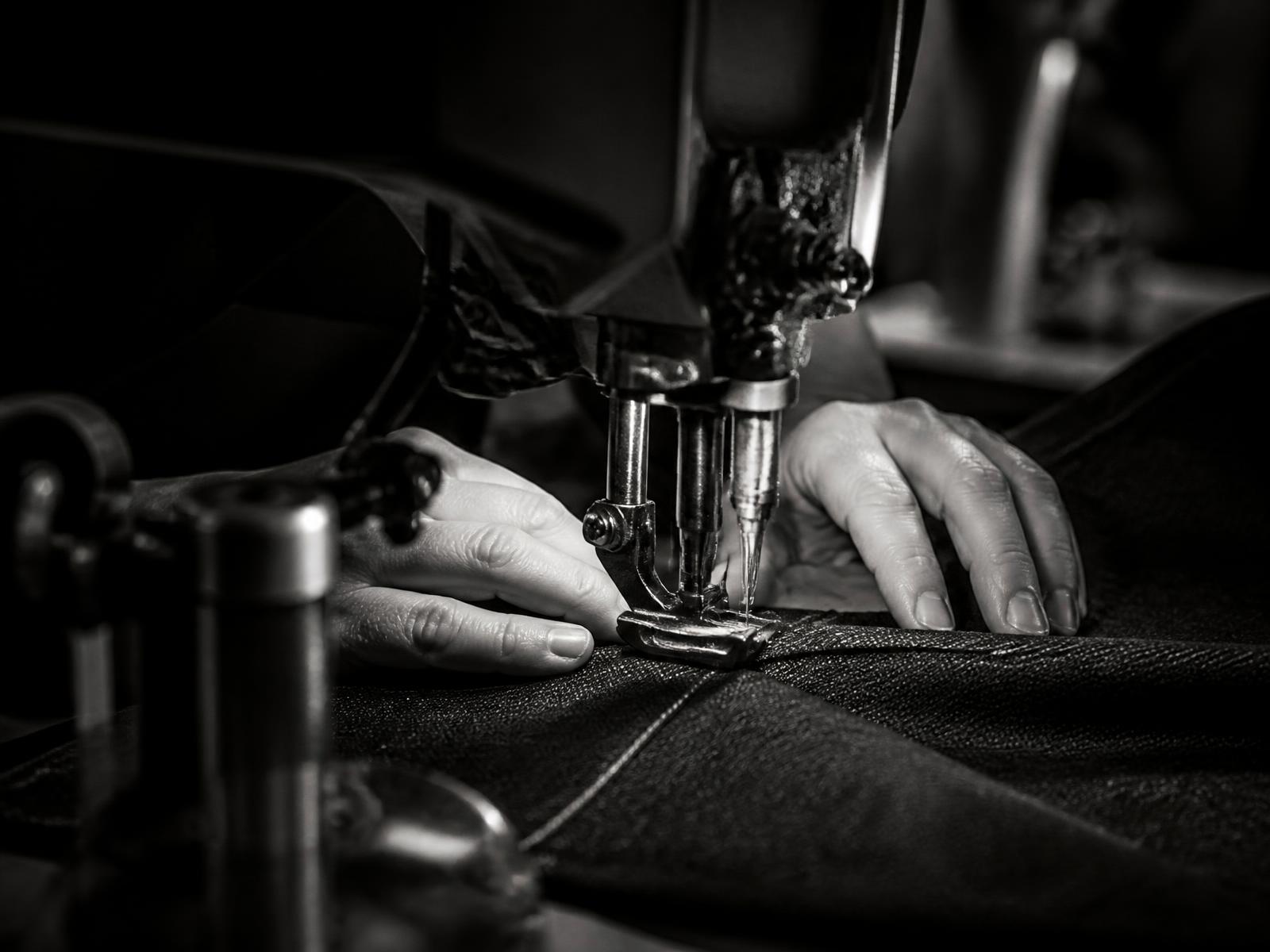 Industrial sewing operation in a denim manufacturing workshop