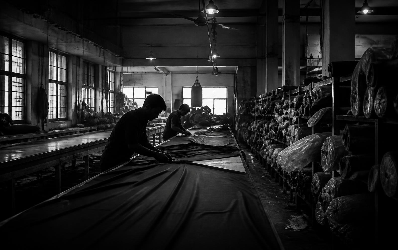 Cutting room of a garment factory with rolls of fabric
